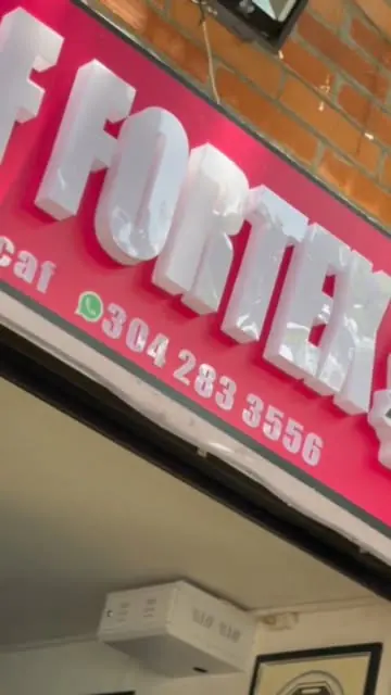 Aviso rojo de Fortex en la fachada, con el número de WhatsApp